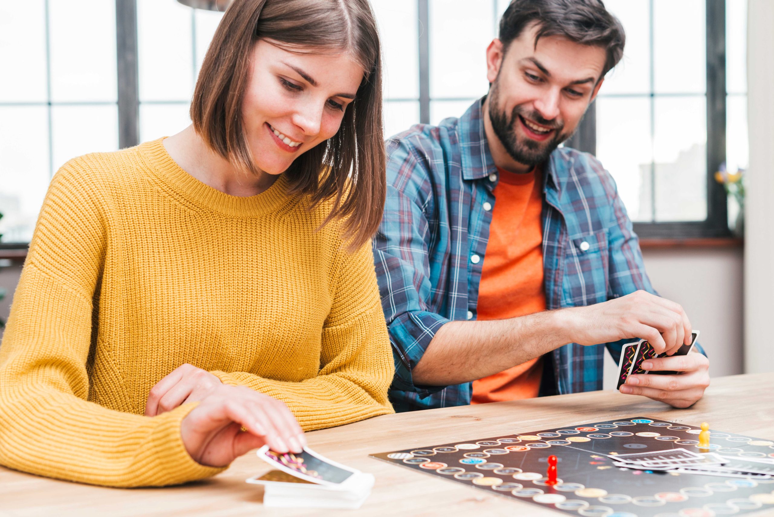 happy-husband-wife-playing-business-card-game-11zon